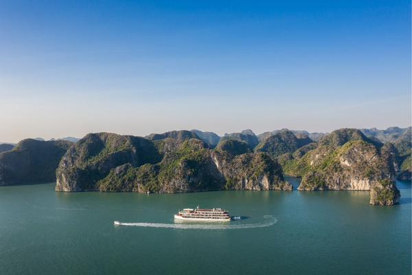 Lan Ha Bay's emerald waters and iconic limestone karsts stretch endlessly beneath open skies