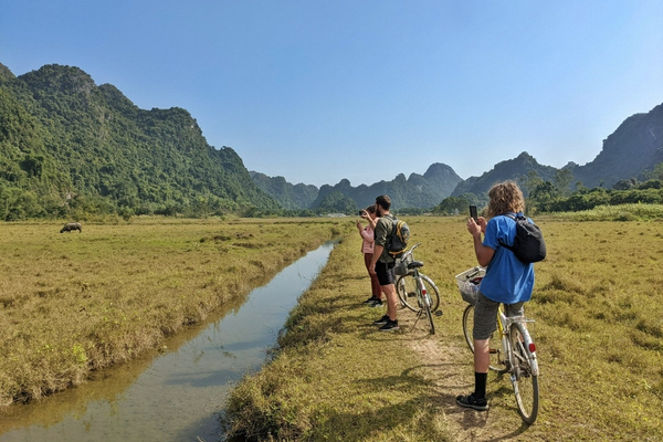 Flat easy paths through rice fields and lush Cat Ba National Park landscapes